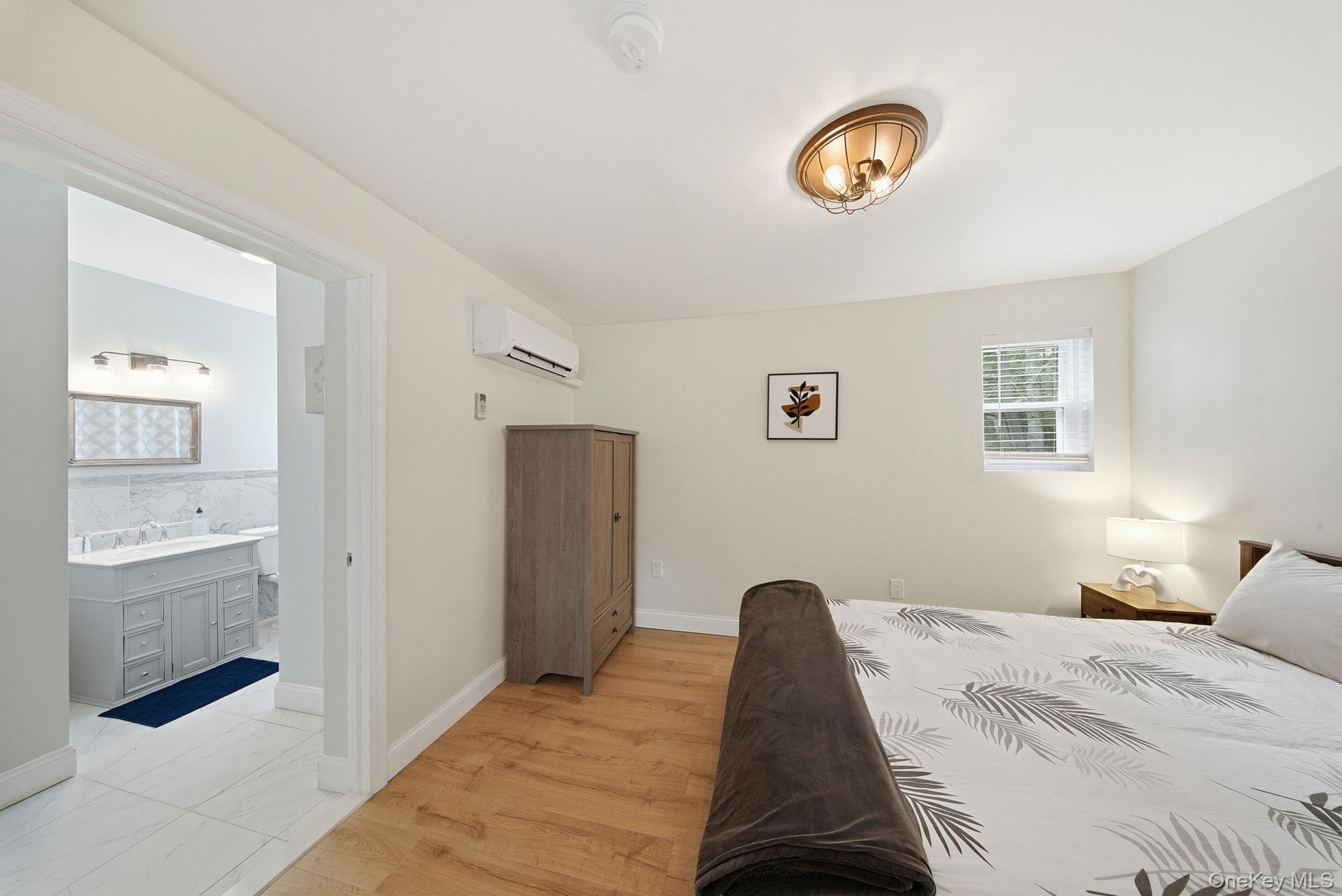 10 Stag Forest Road Forestburgh, NY 12777 - Photo 17 of 44 a bedroom with a bed and a lamp