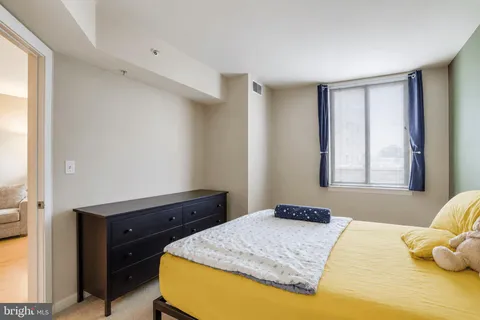 a bedroom with a bed and window