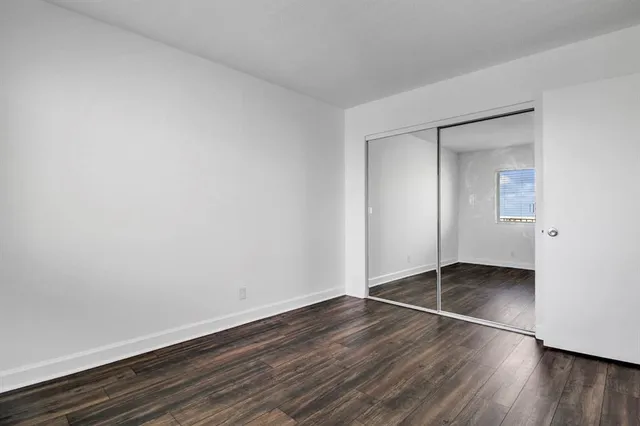 an empty room with wooden floor