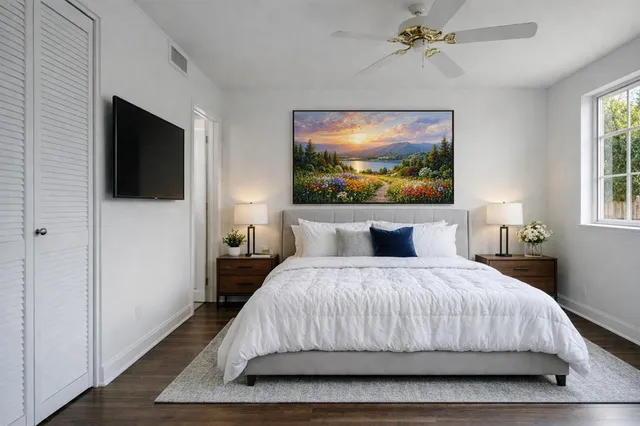 a bedroom with a bed and a flat screen tv