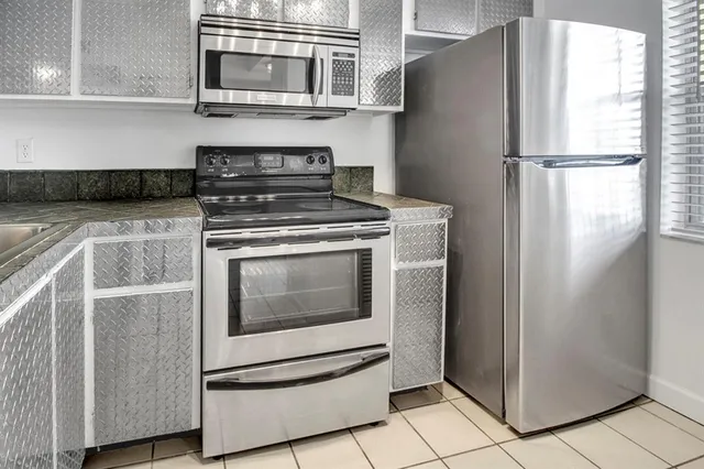 a kitchen with appliances and cabinets