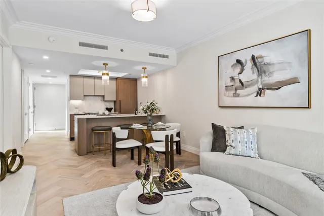 a living room with furniture and kitchen view