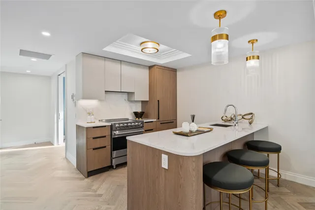 a kitchen with stainless steel appliances a stove a sink and a refrigerator