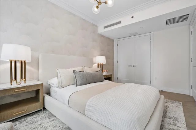 a large white bed in a white room
