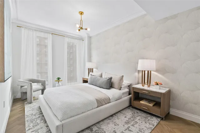 a bedroom with a bed and a chandelier