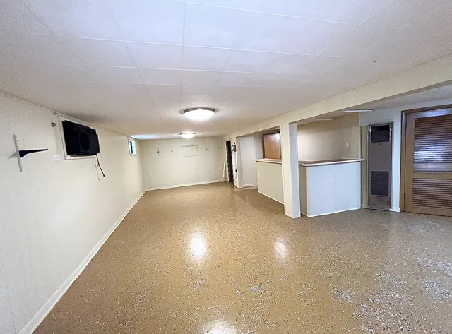 a view of a livingroom with wooden & kitchen