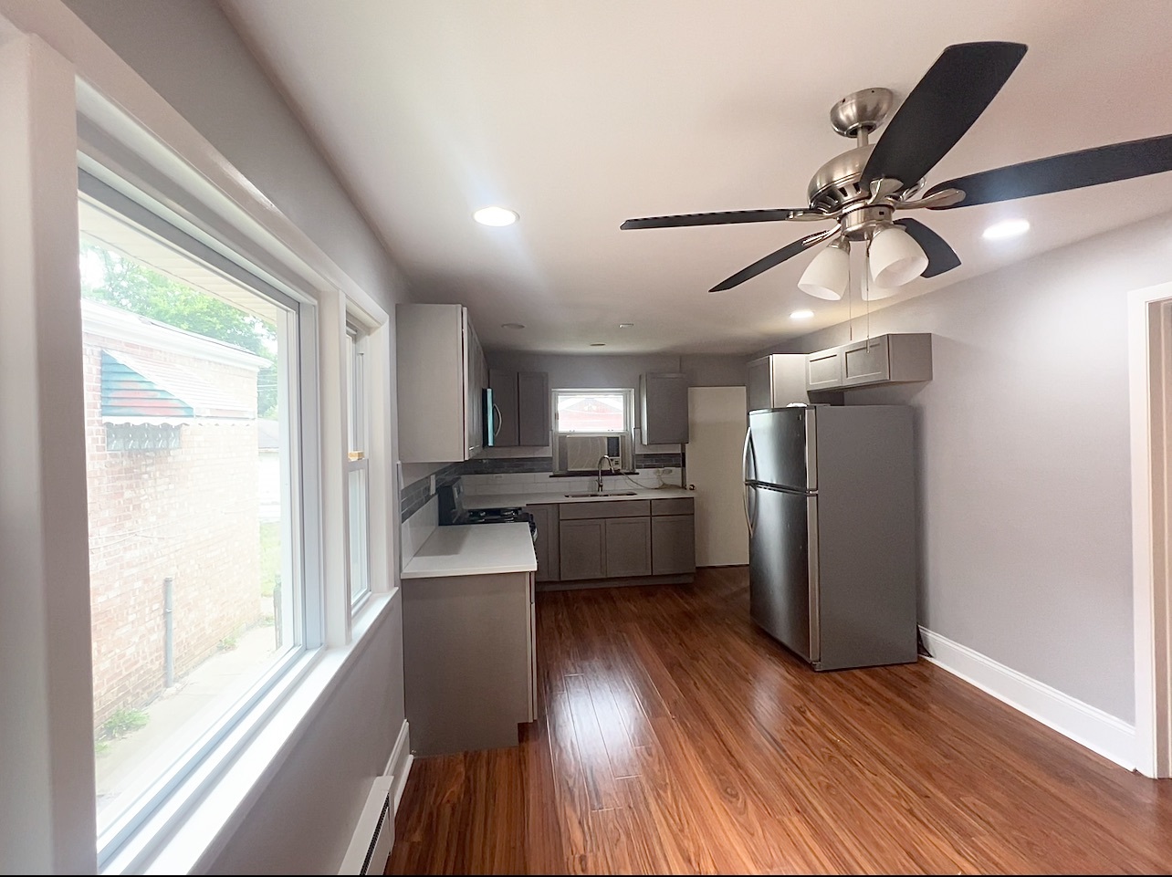 12351 South Union Avenue Chicago, IL 60628 - Photo 3 of 16 a kitchen with a refrigerator a sink and dishwasher with wooden floor