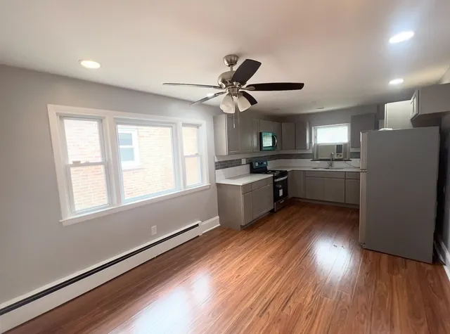 a kitchen with stainless steel appliances a stove a refrigerator and a sink
