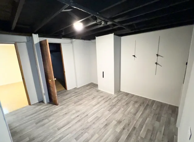 a view of hallway with wooden floor