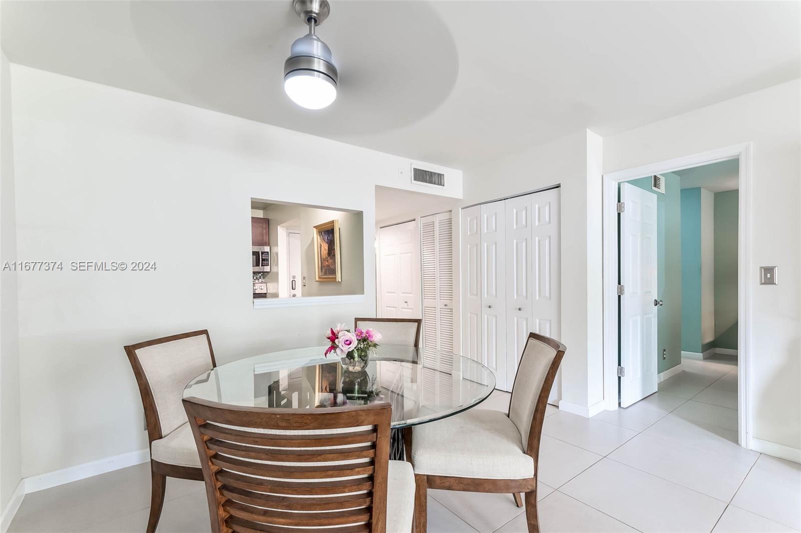 301 Racquet Club Road, Unit 108 Weston, FL 33326 - Photo 11 of 30 a view of a dining room with furniture and wooden floor