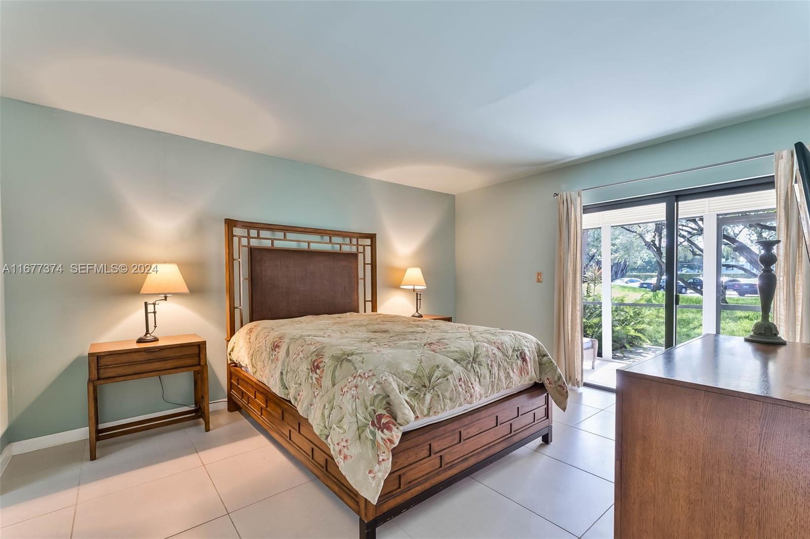 301 Racquet Club Road, Unit 108 Weston, FL 33326 - Photo 12 of 30 a bedroom with a bed and a large window