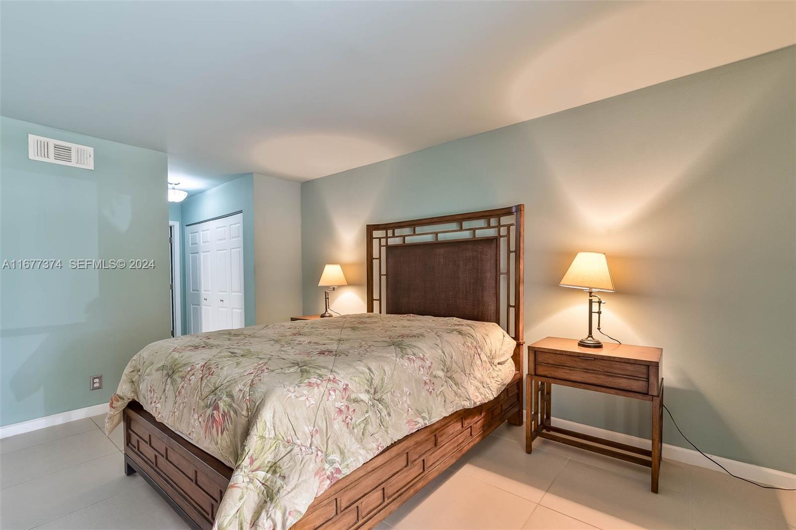 301 Racquet Club Road, Unit 108 Weston, FL 33326 - Photo 13 of 30 a bedroom with a bed and a lamp