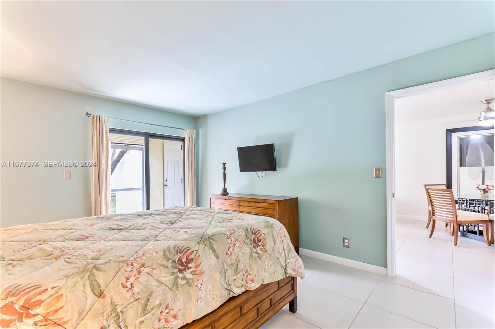 301 Racquet Club Road, Unit 108 Weston, FL 33326 - Photo 14 of 30 a bedroom with a bed and chair