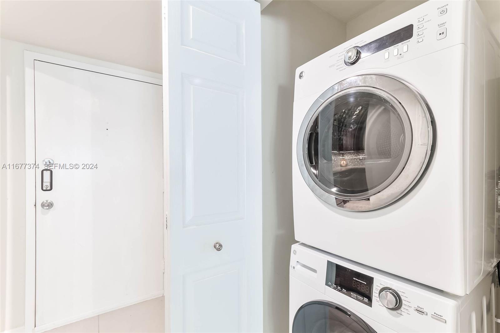 301 Racquet Club Road, Unit 108 Weston, FL 33326 - Photo 16 of 30 a utility room with dryer and washer