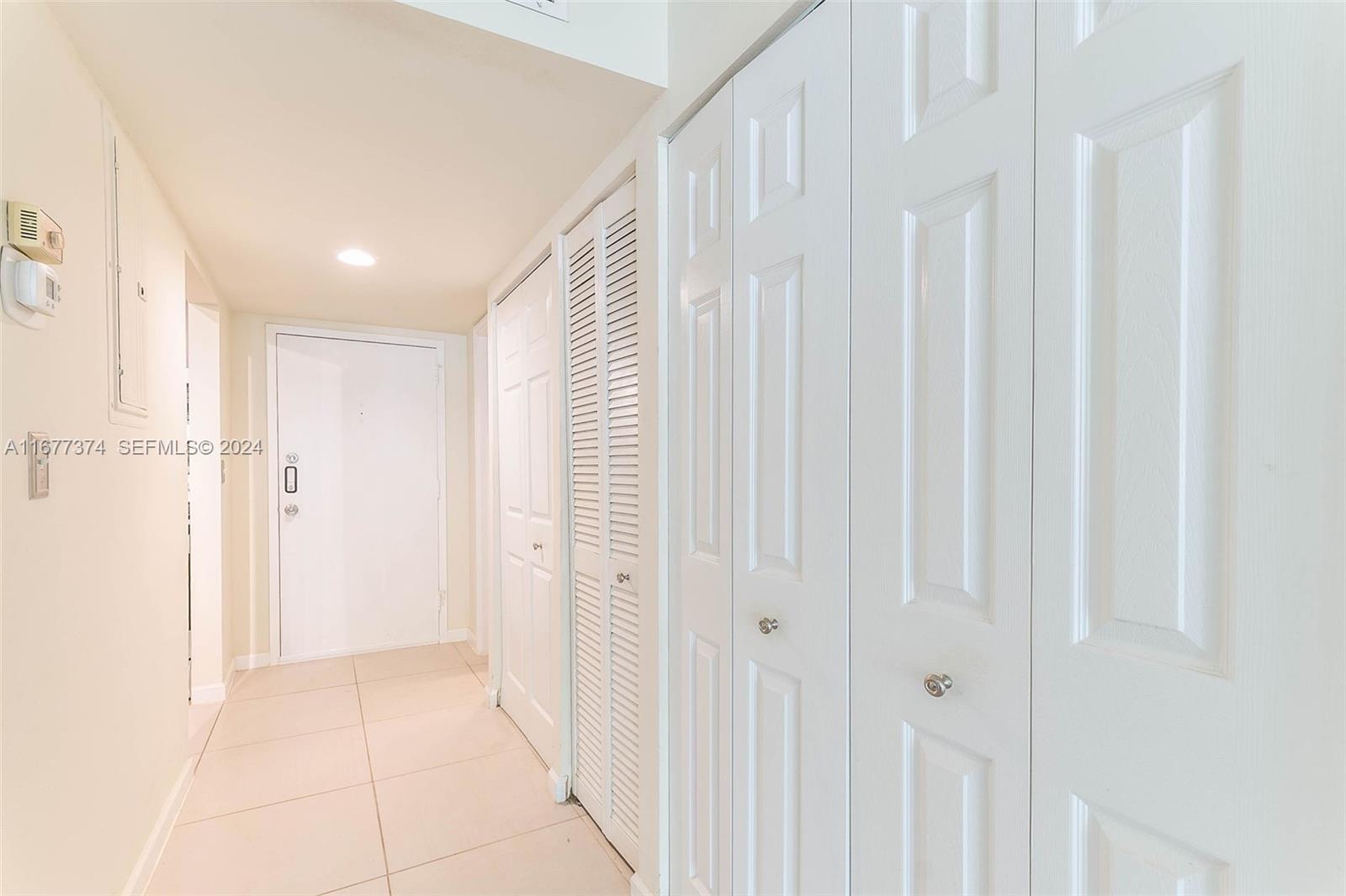 301 Racquet Club Road, Unit 108 Weston, FL 33326 - Photo 19 of 30 a view of a hallway with a wooden floor