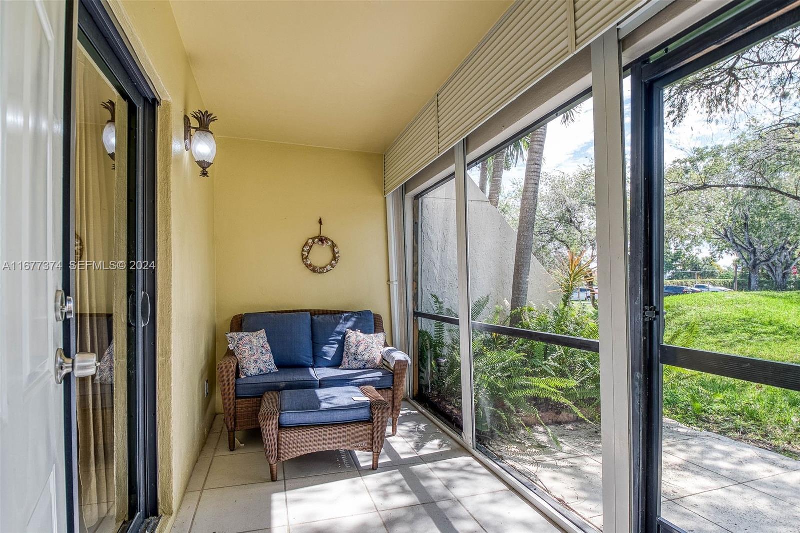 301 Racquet Club Road, Unit 108 Weston, FL 33326 - Photo 22 of 30 a outdoor living space with furniture