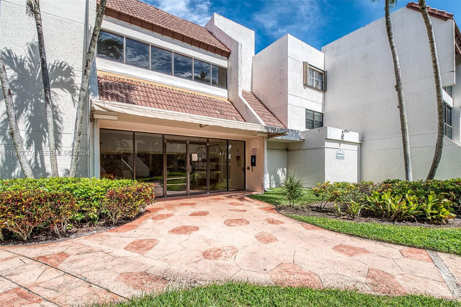 301 Racquet Club Road, Unit 108 Weston, FL 33326 - Photo 25 of 30 a front view of a house with garden