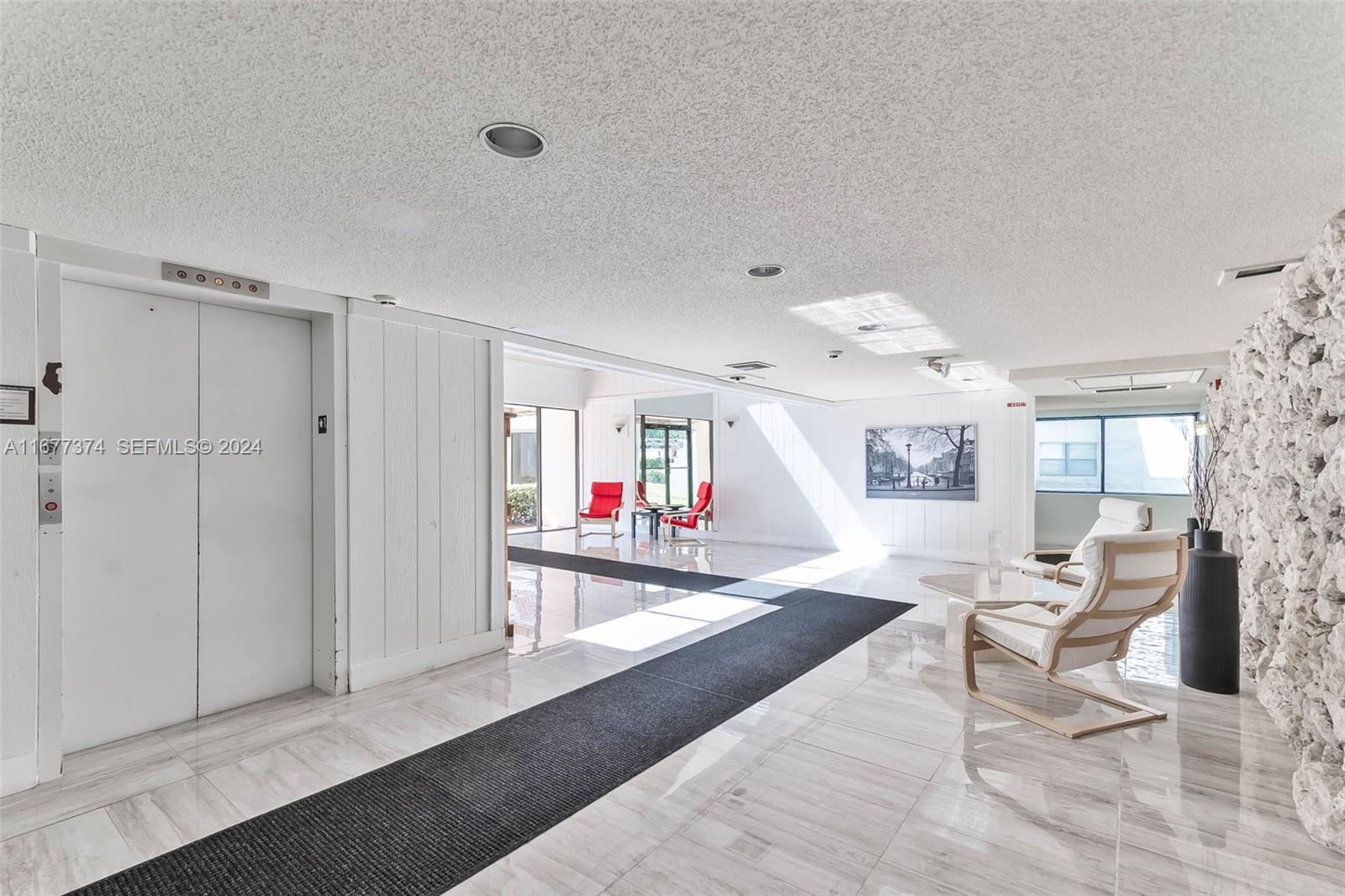 301 Racquet Club Road, Unit 108 Weston, FL 33326 - Photo 27 of 30 a living room with furniture and a wooden floor