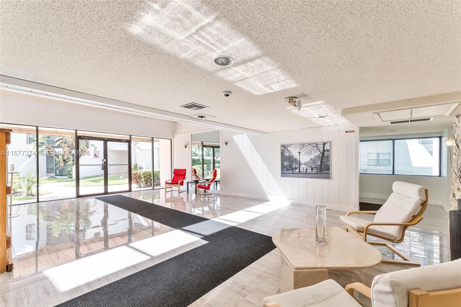 301 Racquet Club Road, Unit 108 Weston, FL 33326 - Photo 28 of 30 a living room with furniture and a large window