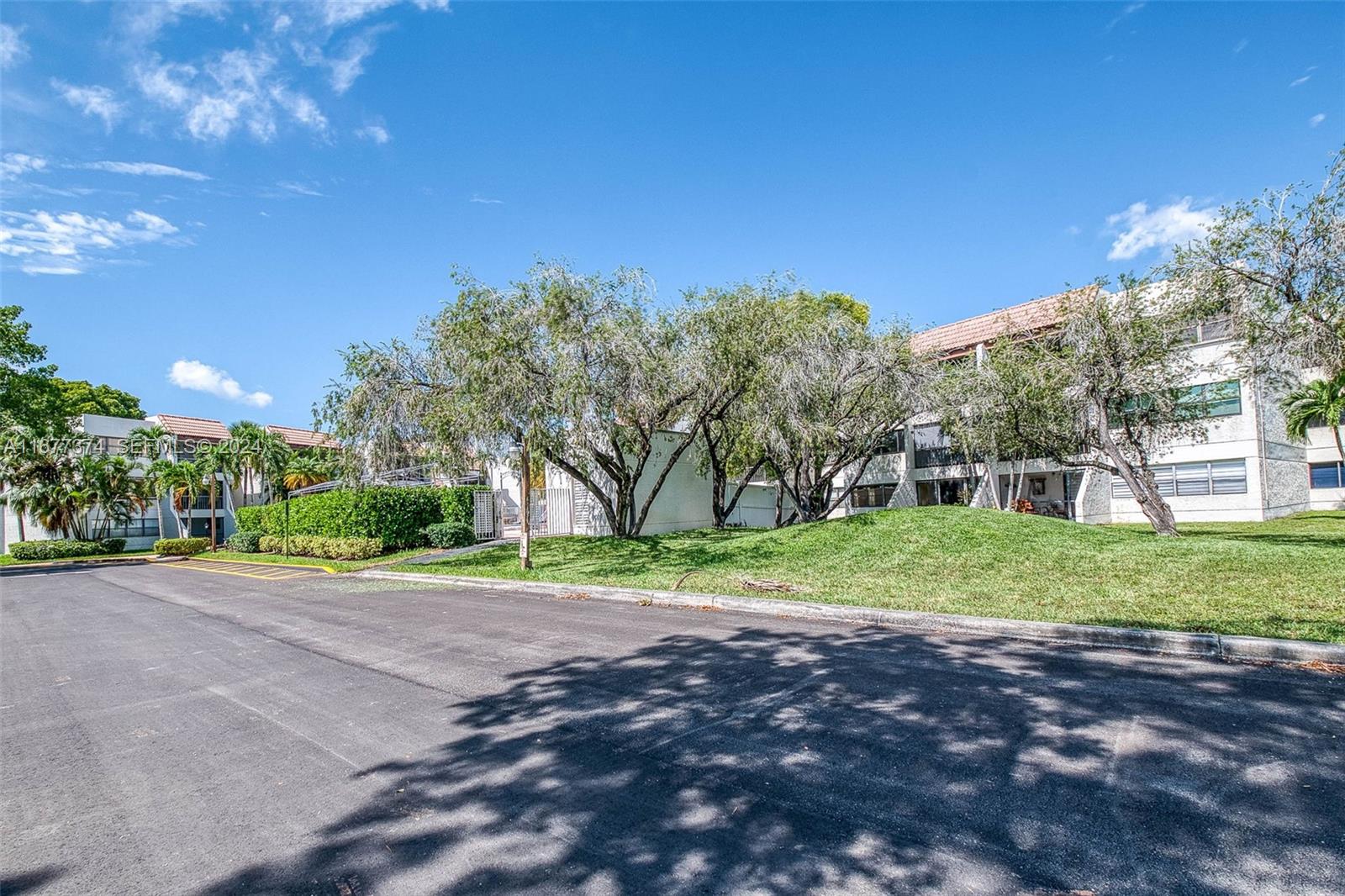 301 Racquet Club Road, Unit 108 Weston, FL 33326 - Photo 30 of 30 a view of a yard with a house and tree s