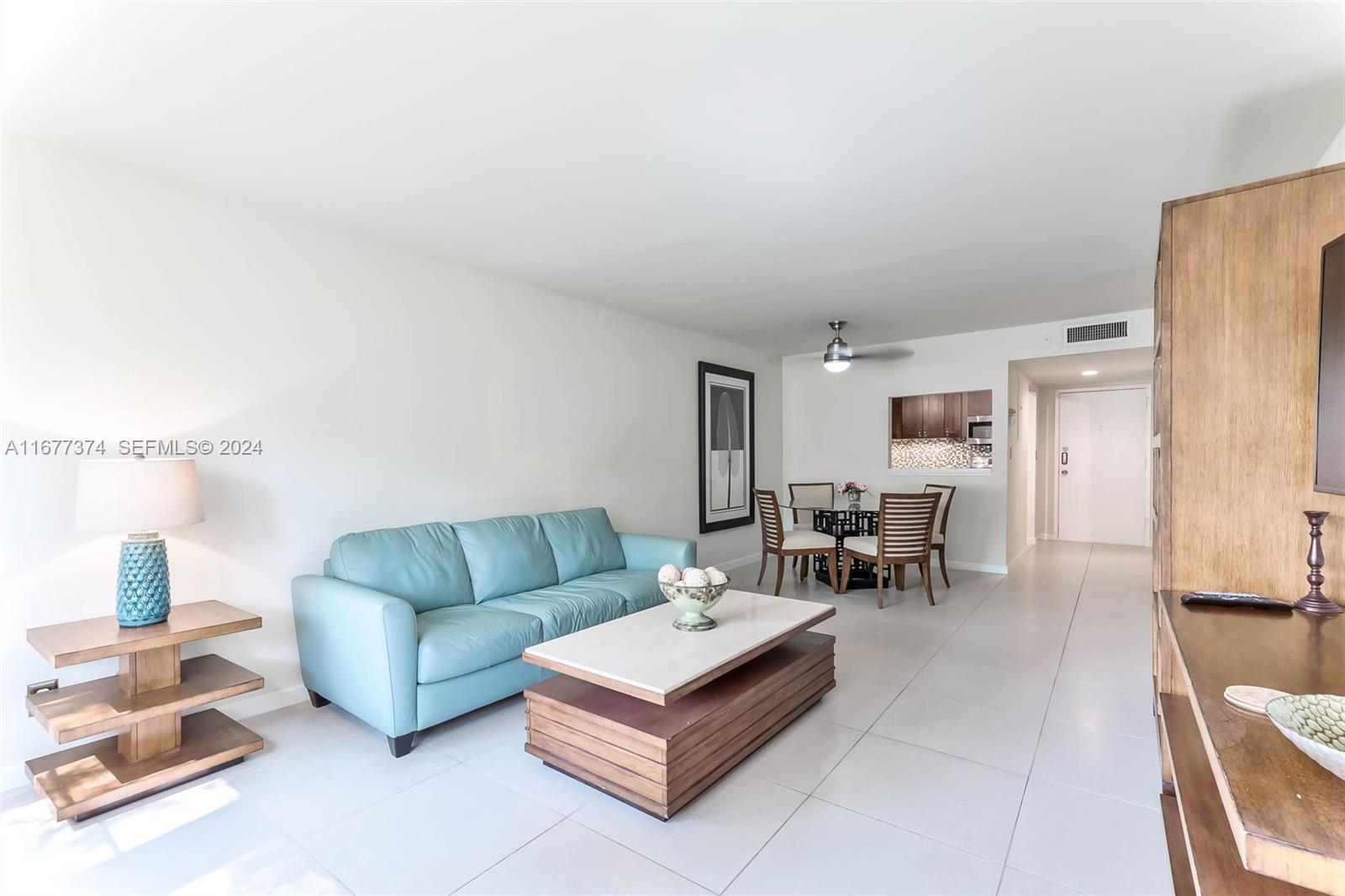 301 Racquet Club Road, Unit 108 Weston, FL 33326 - Photo 6 of 30 a living room with furniture and a couch