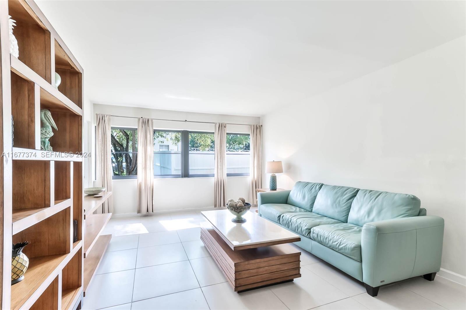 301 Racquet Club Road, Unit 108 Weston, FL 33326 - Photo 7 of 30 a living room with furniture and a couch