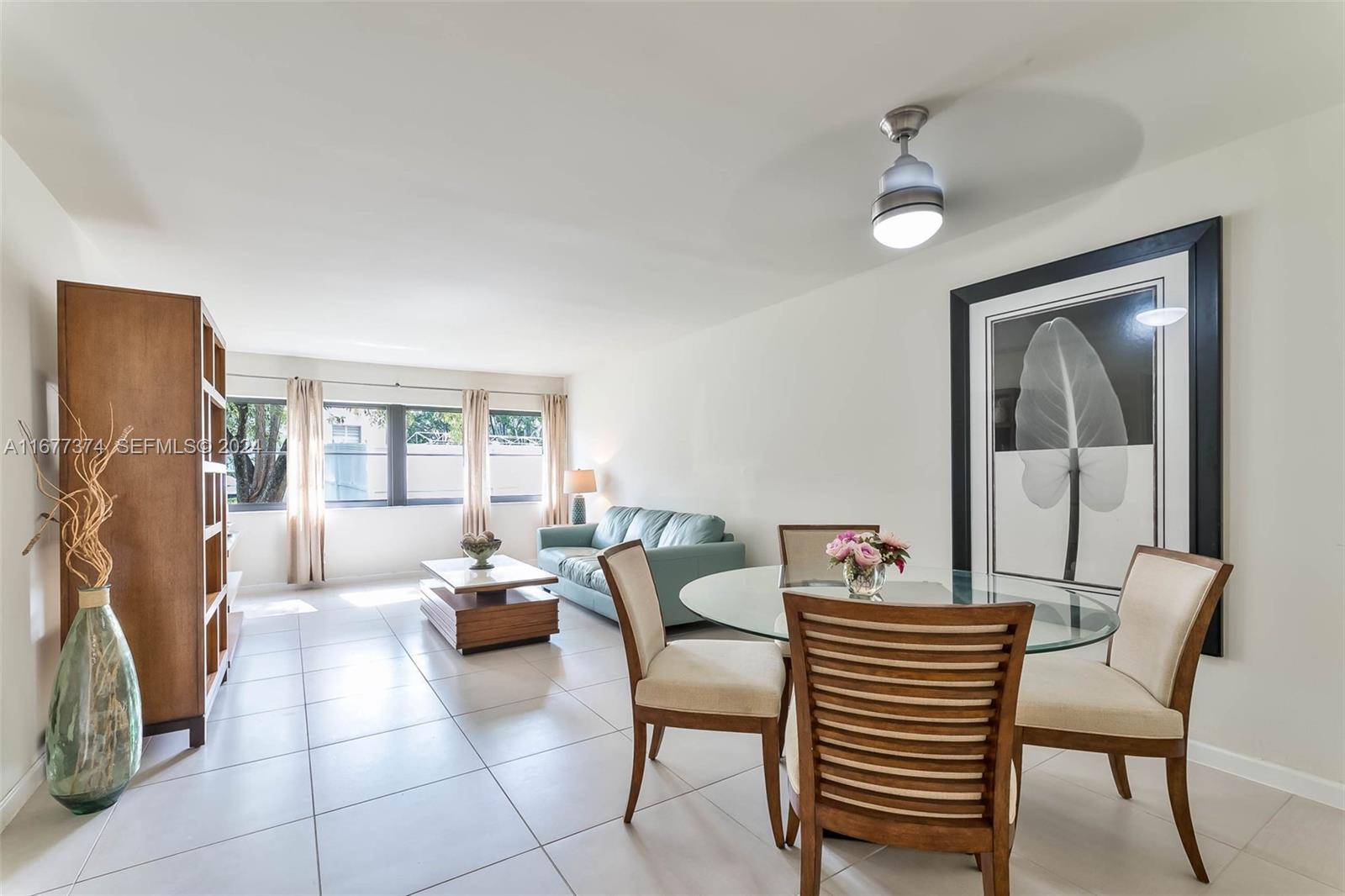 301 Racquet Club Road, Unit 108 Weston, FL 33326 - Photo 9 of 30 a living room with furniture and a window