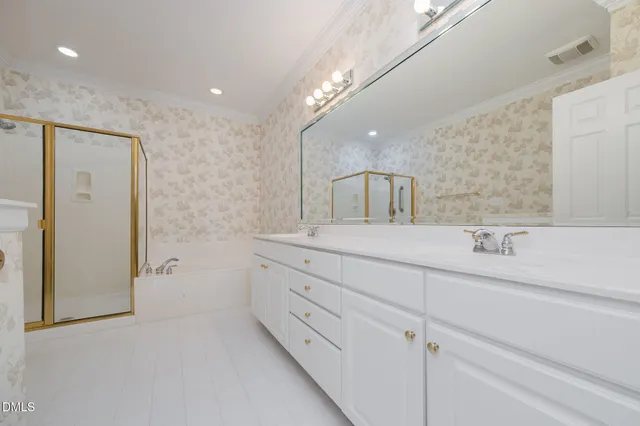 a bathroom with a double vanity sink mirror and shower