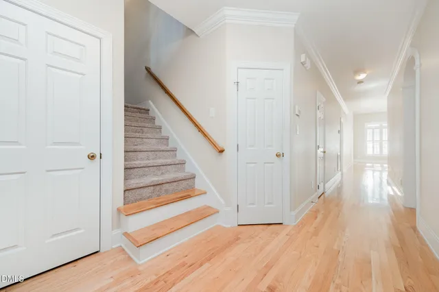 a view of a hallway with wooden floor and entryway