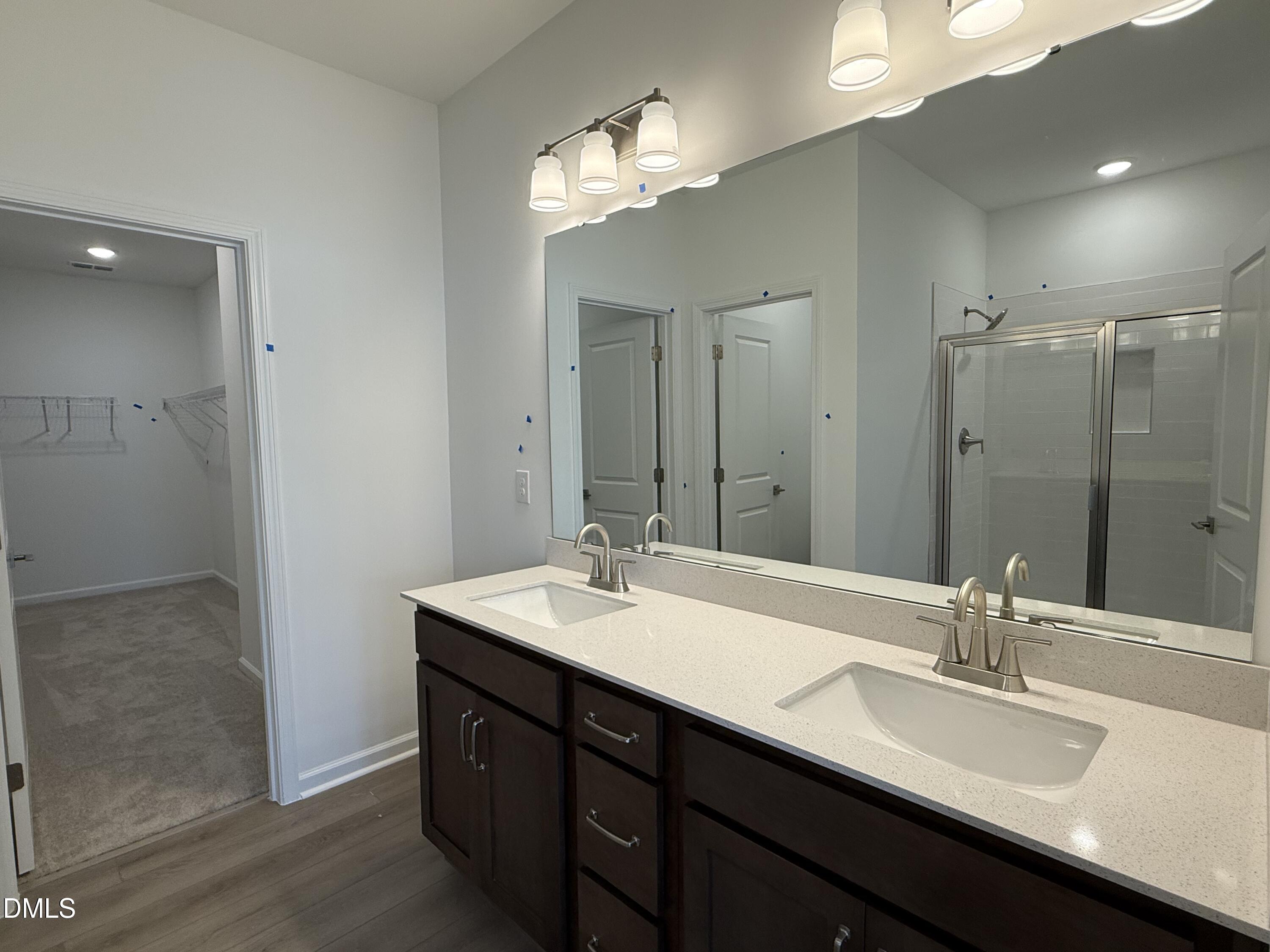 2844 Quarry Road, Unit 173 Rolesville, NC 27571 - Photo 14 of 31 a bathroom with a double vanity sink and a mirror
