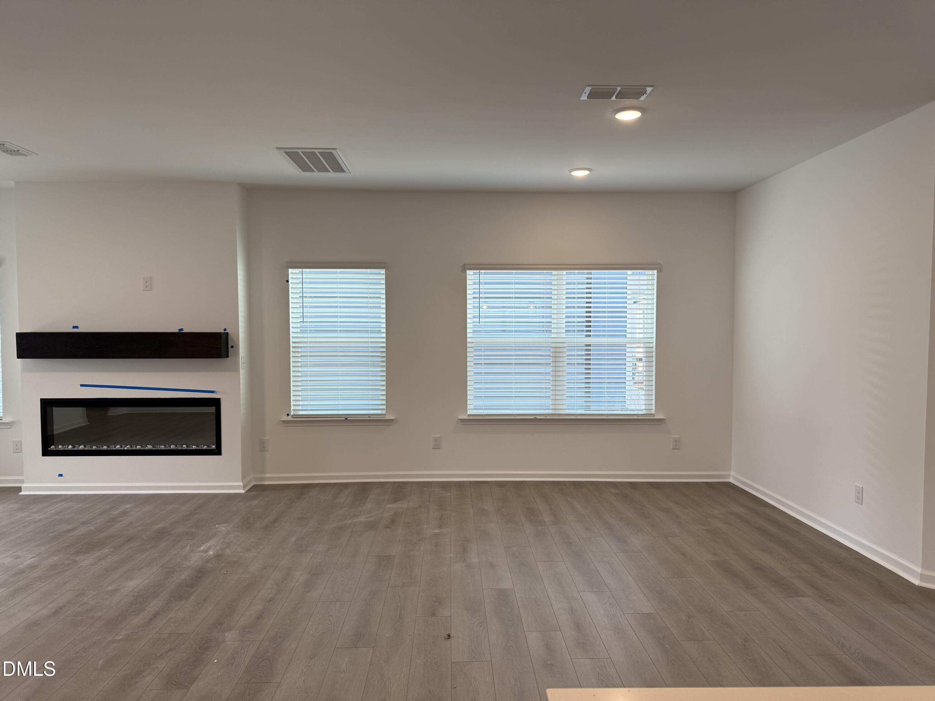 2844 Quarry Road, Unit 173 Rolesville, NC 27571 - Photo 8 of 31 a view of an empty room with a fireplace and a window