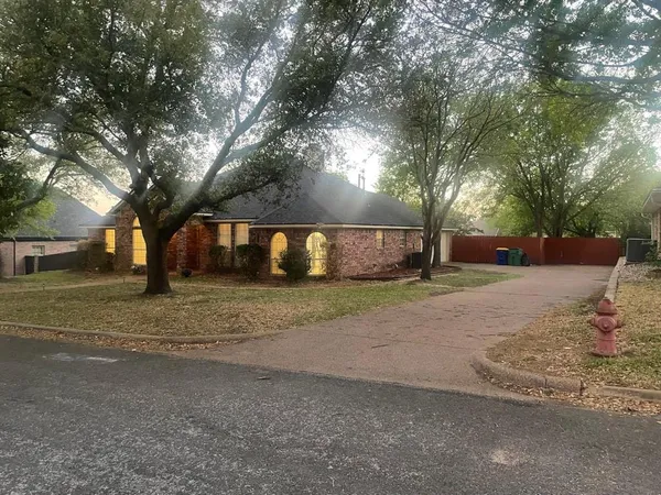 a view of road with large trees
