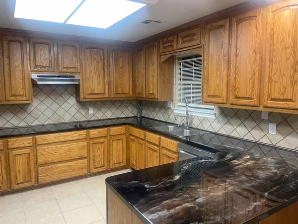a kitchen with granite countertop cabinets and a sink