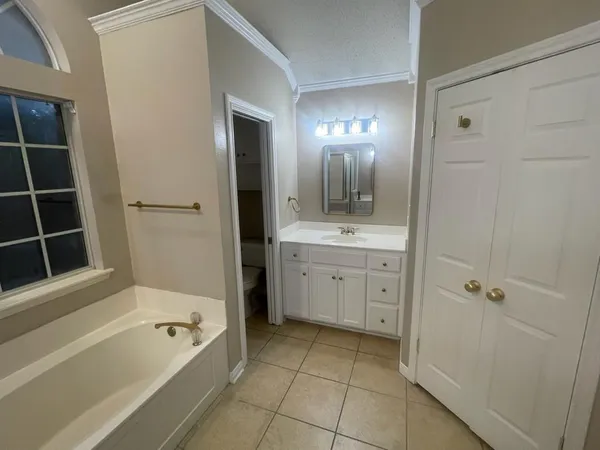a bathroom with a granite countertop sink a toilet and bathtub