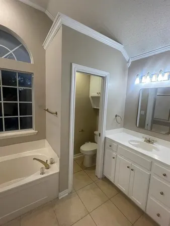 a room with white cabinets and a sink
