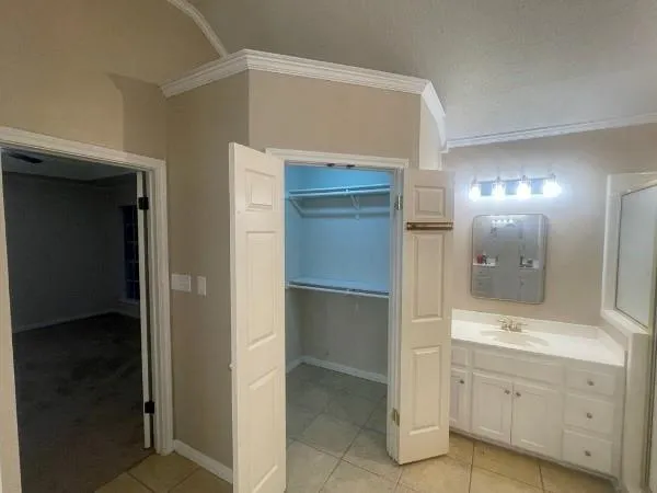 a bathroom with a glass shower door and a sink