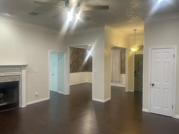 an empty room with wooden floor and fireplace