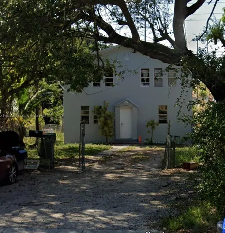 a house that has a tree in front of it