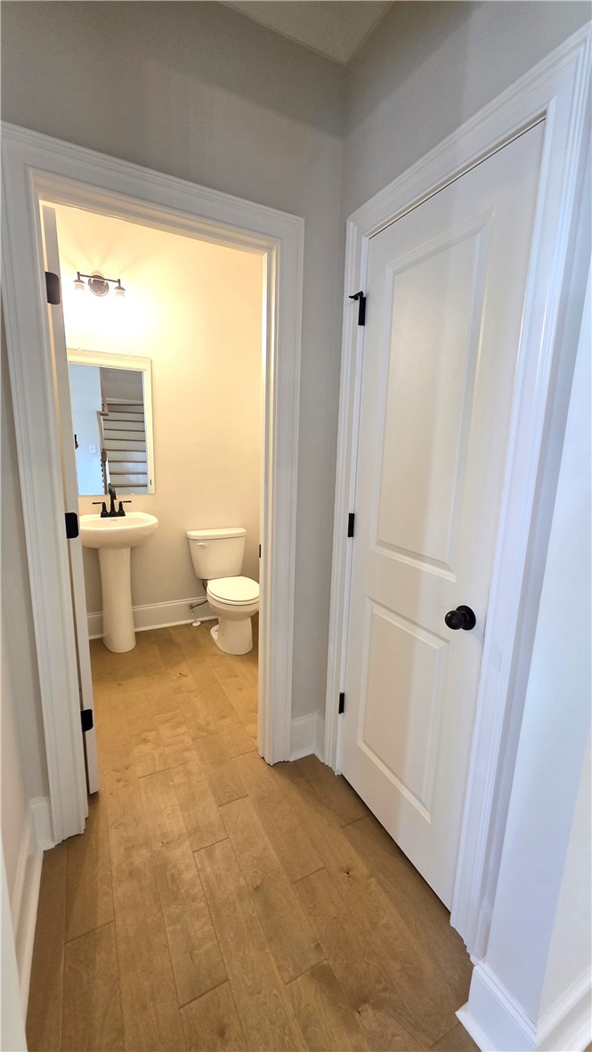 243 Holly Br Road Piedmont, SC 29673 - Photo 5 of 21 A compact, modern powder room offers convenience with light hardwood floors.