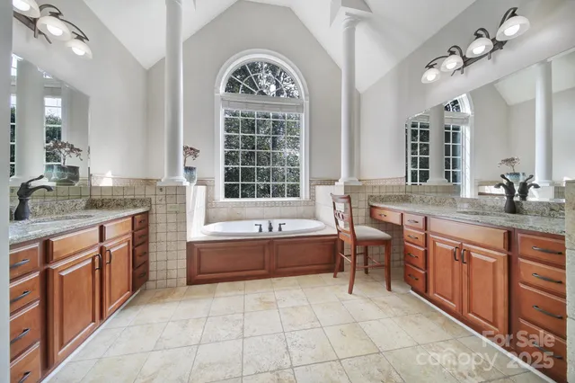 a spacious bathroom with a granite countertop sink mirror and shower