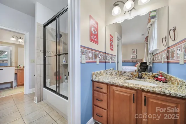a bedroom with a bed window and a flat screen tv
