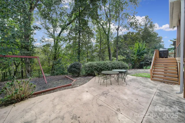 a view of a chairs and table in backyard