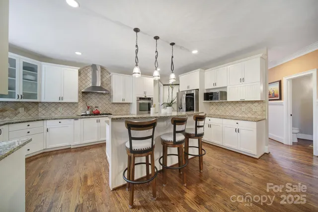a large kitchen with lots of counter space and stainless steel appliances