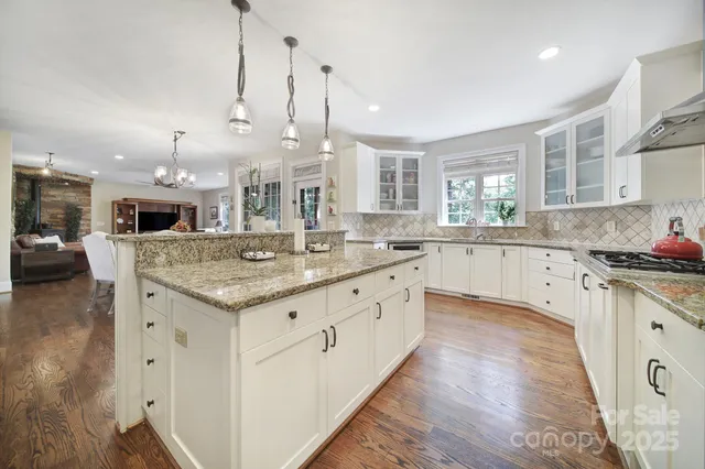 a large kitchen with stainless steel appliances kitchen island granite countertop a large counter top and sink