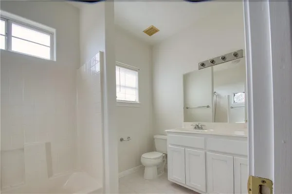 a bathroom with a toilet sink and mirror