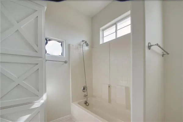 a bathroom with a bathtub and shower
