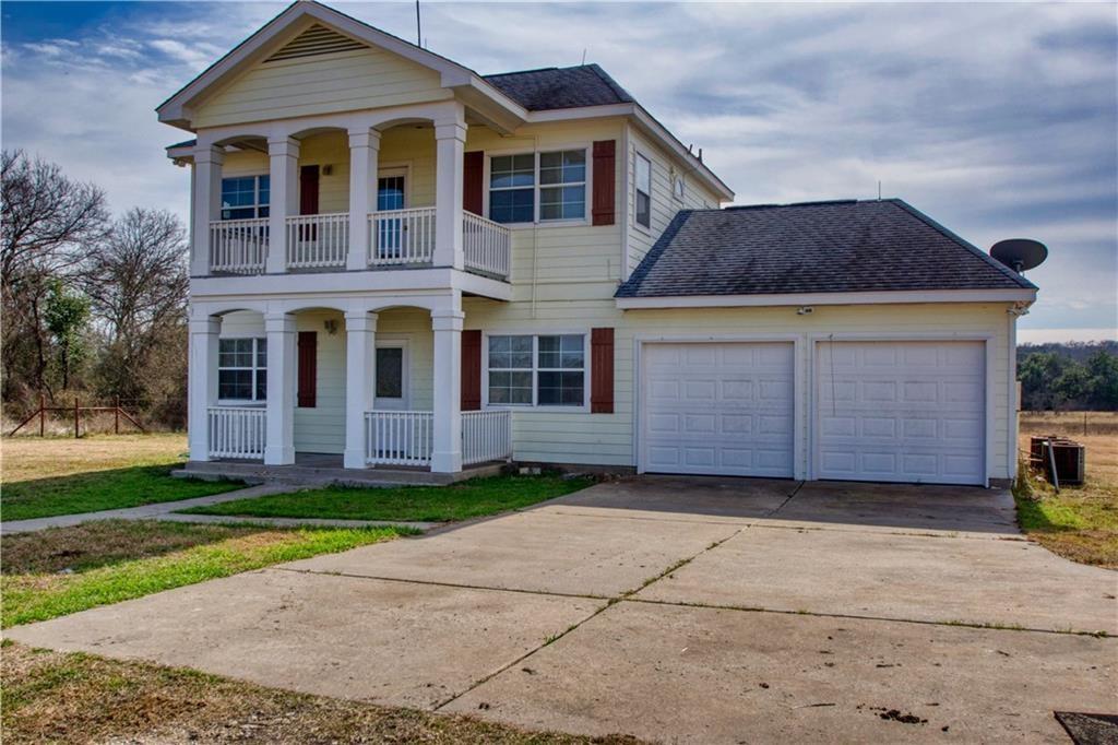 1770 County Road 329 Granger, TX 76530 - Photo 2 of 23 a front view of a house with a garden
