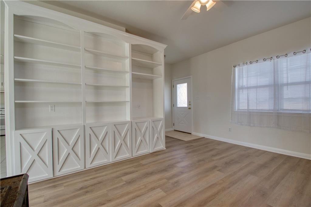 1770 County Road 329 Granger, TX 76530 - Photo 7 of 23 a view of an empty room with wooden floor and a window