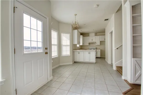 a view of a kitchen with dishwasher and white cabinets