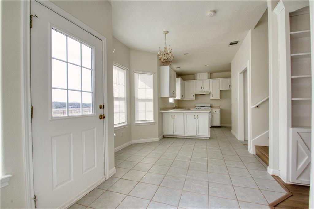 1770 County Road 329 Granger, TX 76530 - Photo 8 of 23 a view of a kitchen with dishwasher and white cabinets